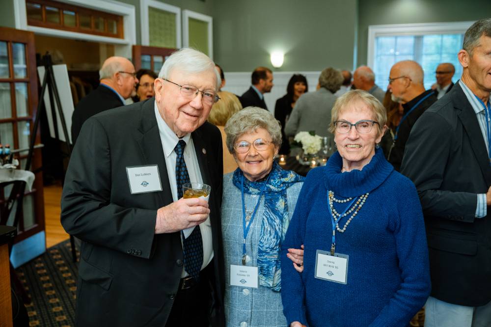 president lubbers smiling with two women